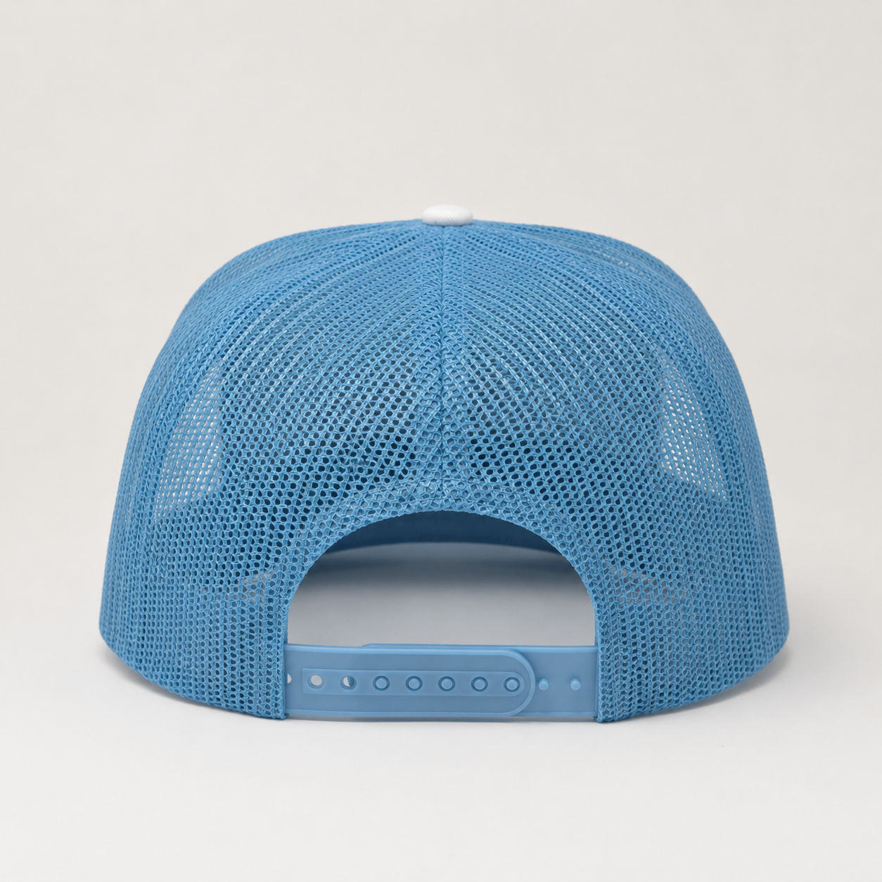 Back view of adjustable mesh snapback trucker hat in sky blue