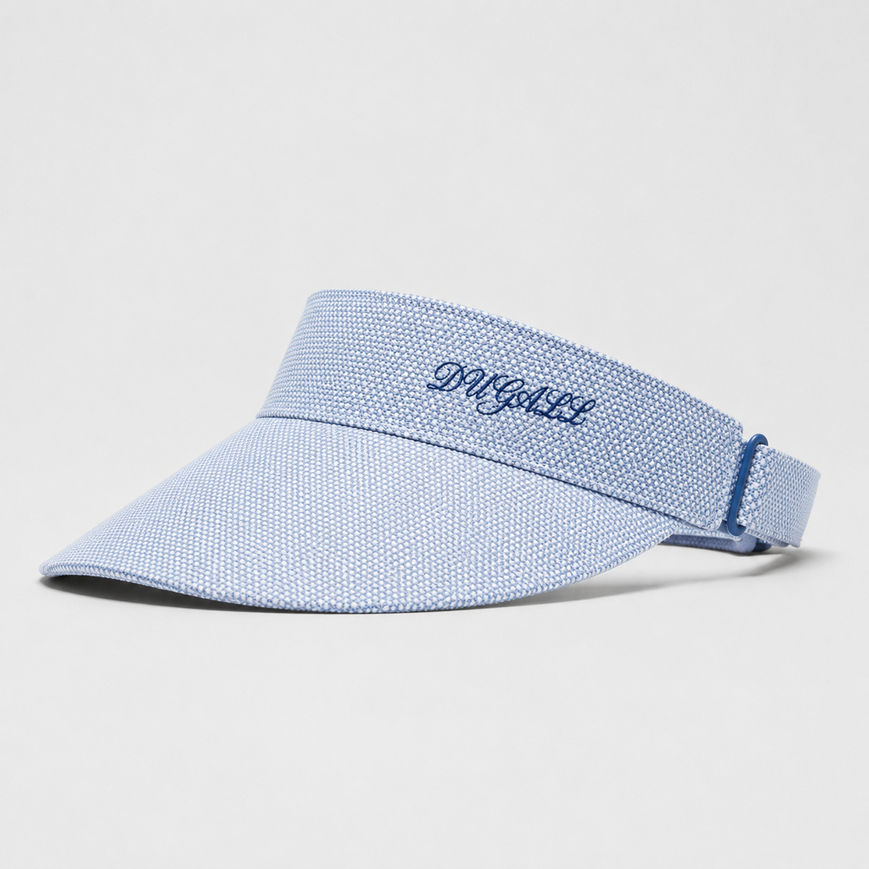 A light blue textured visor hat with a matching adjustable strap, featuring the brand name 'D'AGUIL' embroidered in navy blue on the front band, set against a plain light gray background.