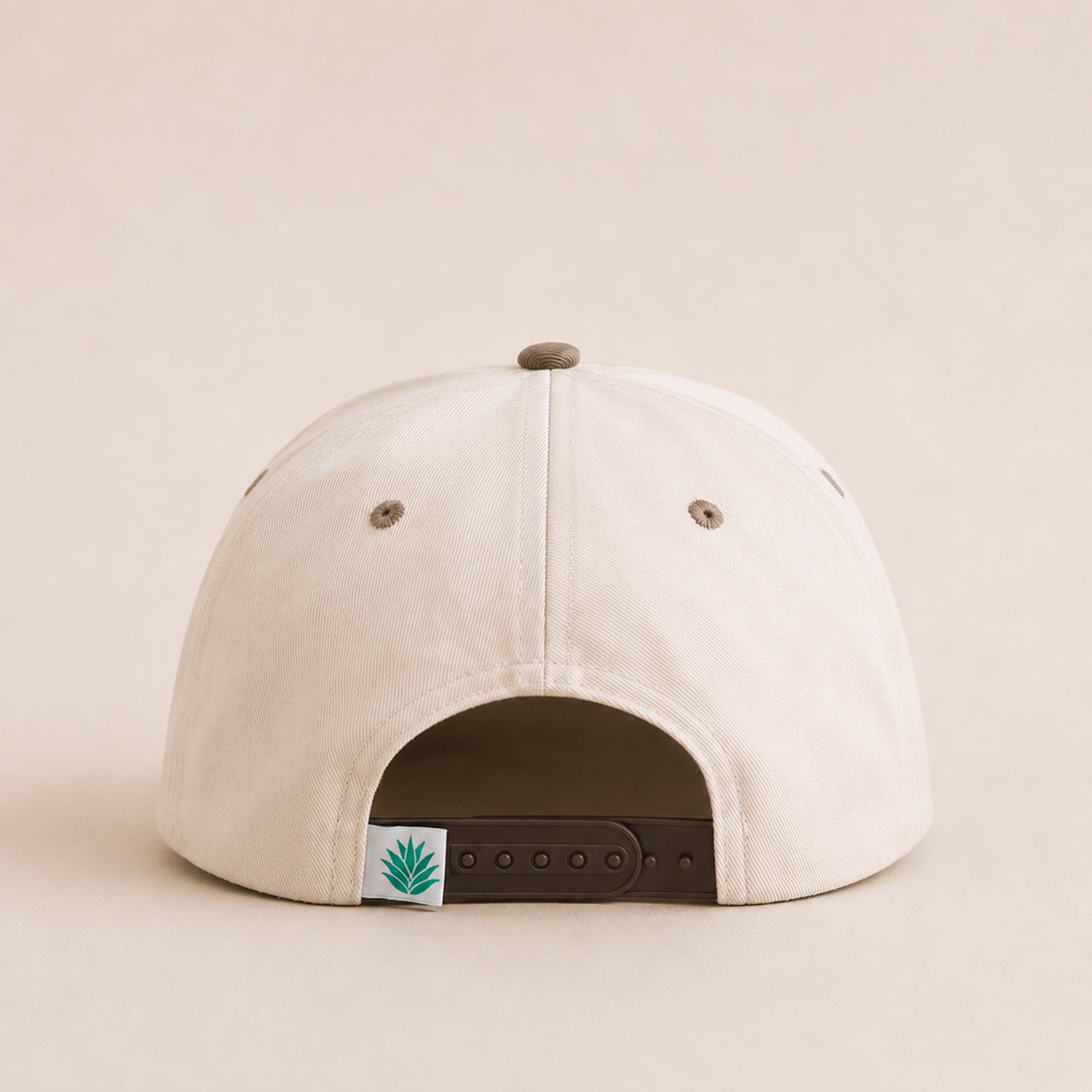 Back view of adjustable snapback closure on distressed denim cap