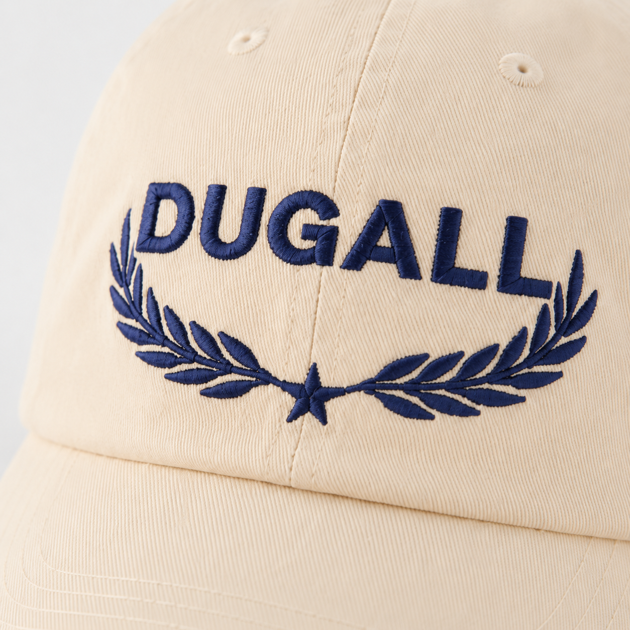Close-up of custom embroidered logo and wheat pattern on cotton linen cap