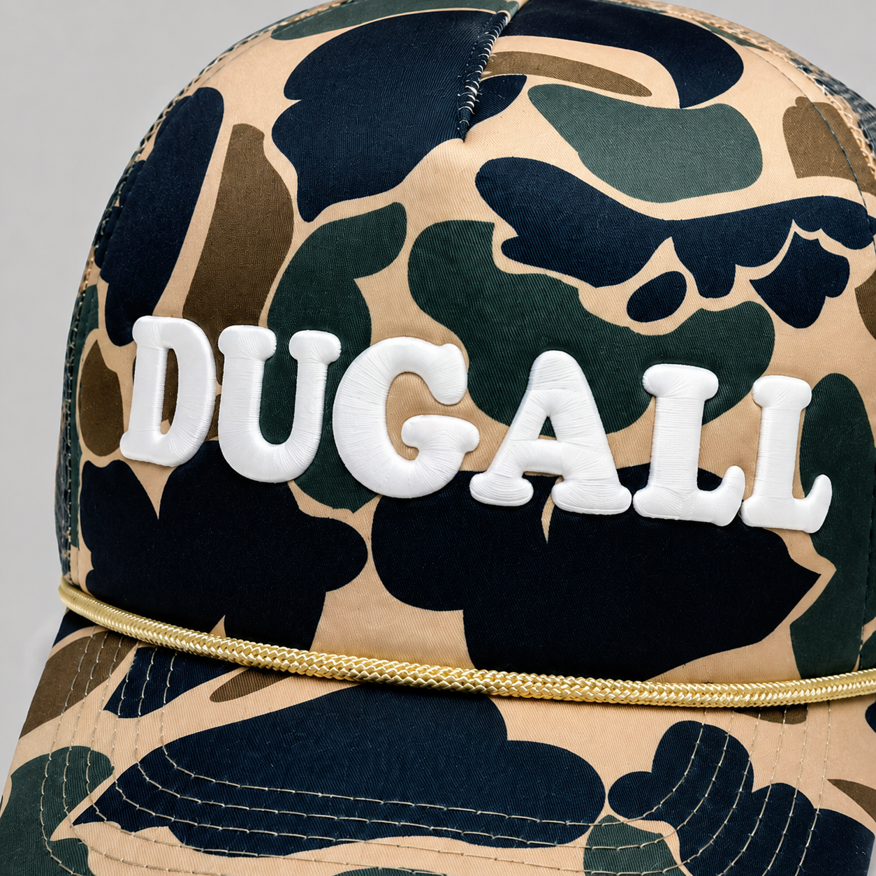 Close-up of custom 3D print logo on printed camo trucker hat