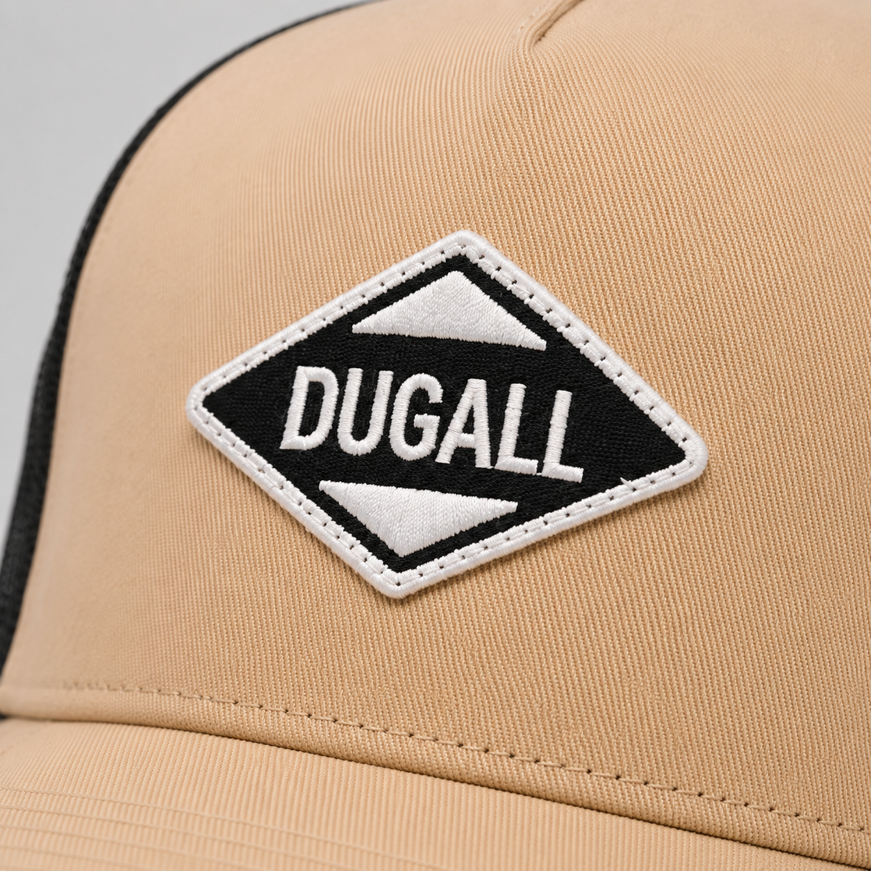 Close-up of custom embroidered patch logo on a durable cotton twill trucker hat.