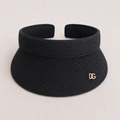 Front view of black raffia sun visor with wide curved brim, UV protection design, and custom metal logo.