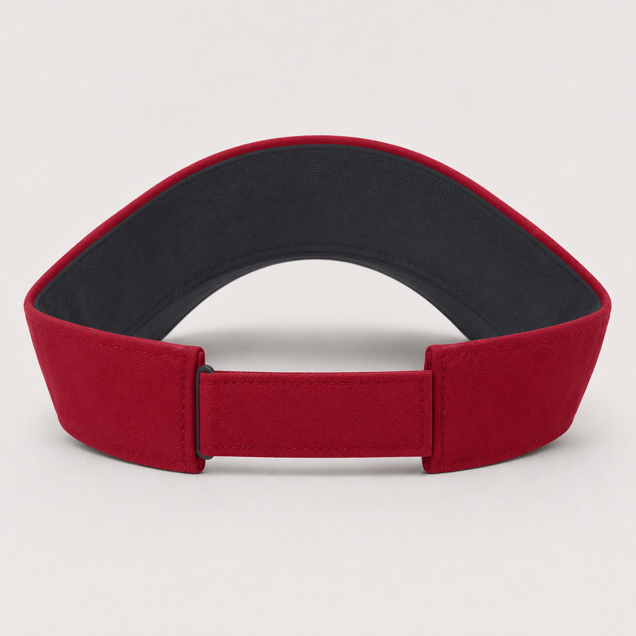 A red padded headband with a black inner lining, shown from the back on a light gray background.