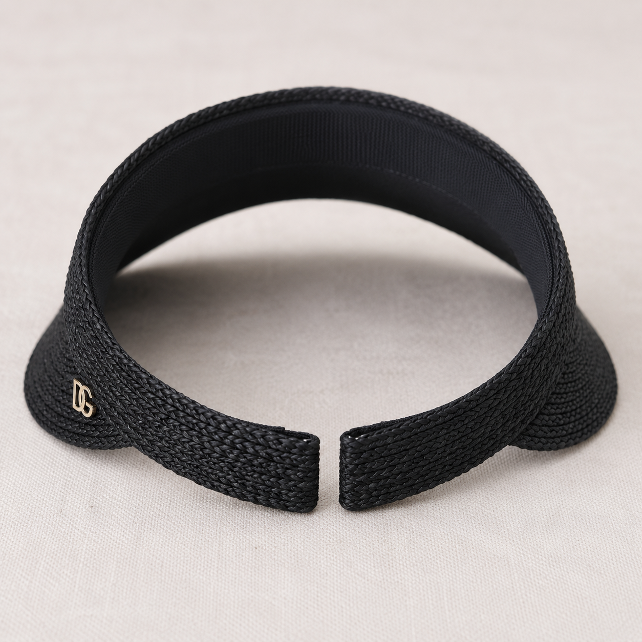 Back view of black raffia sun visor with open-top design, breathable woven texture, and comfortable fit.