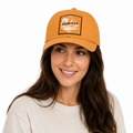 Model wearing custom cotton baseball cap with embroidered patch logo