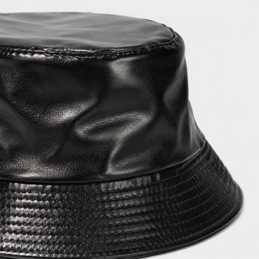 Close-up of glossy PU leather texture on a black faux leather bucket hat
