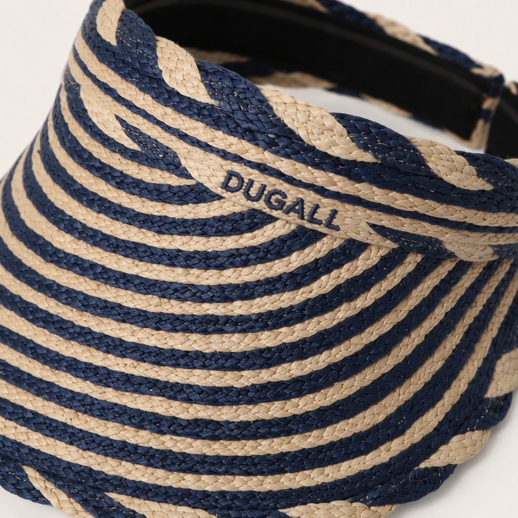 A close-up of a woven visor hat with alternating navy blue and natural beige stripes, featuring the brand name 'DUGALL' embroidered on the side.