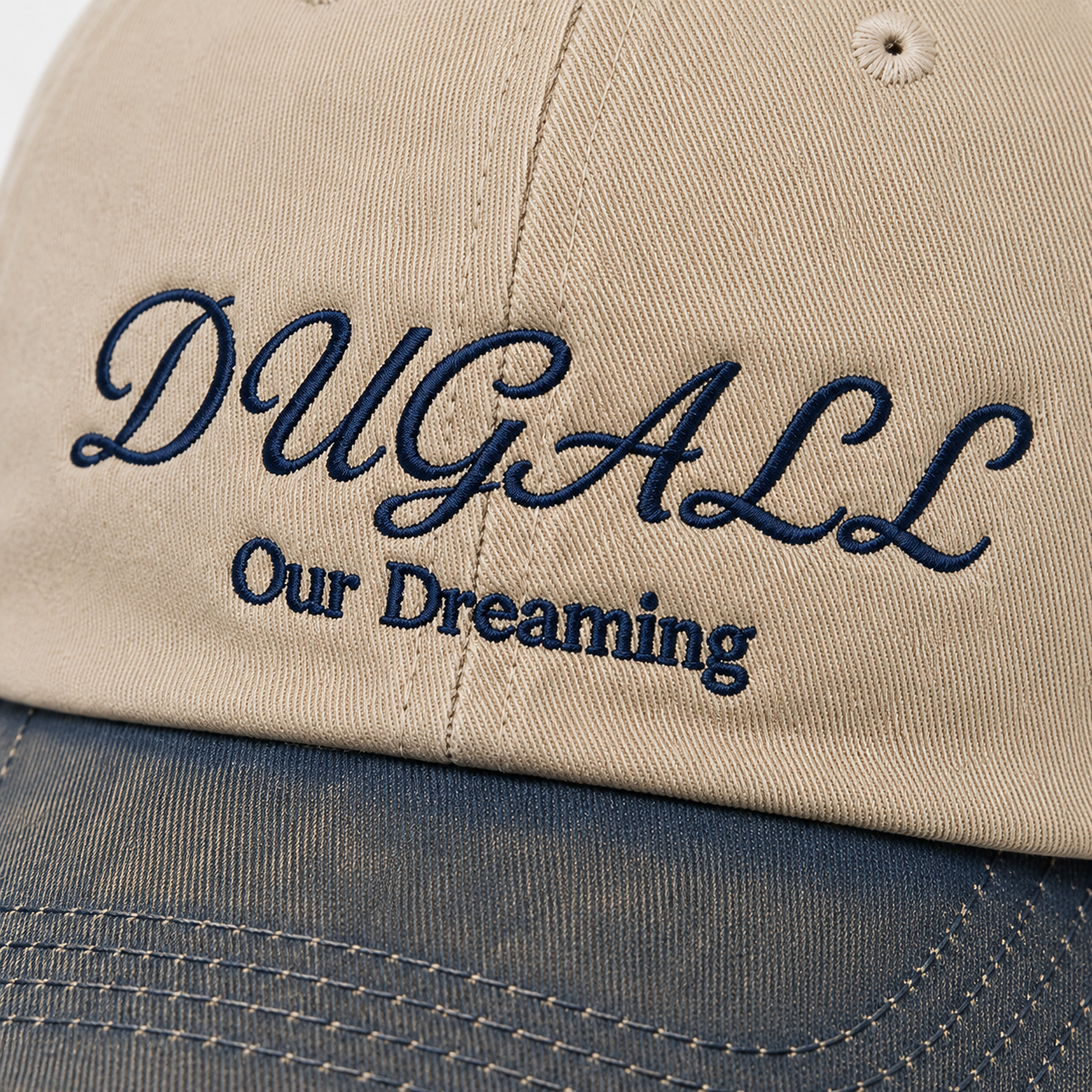 Close-up of custom script embroidery on washed cotton cap