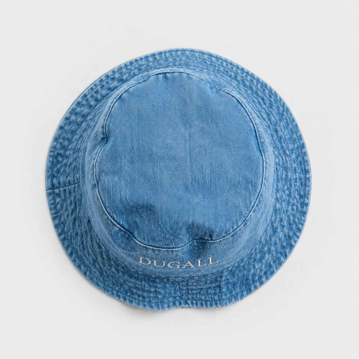 Top view of washed denim canvas bucket hat with soft brim, custom embroidery logo placement, and vintage blue texture.