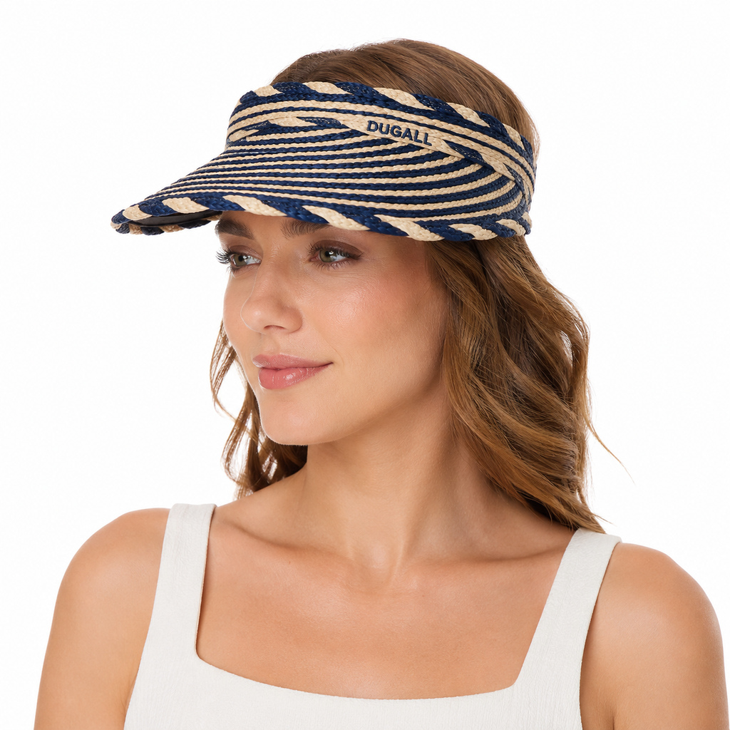A woman wearing a Dugali brand woven visor with navy blue and beige horizontal stripes, shown against a plain white background.