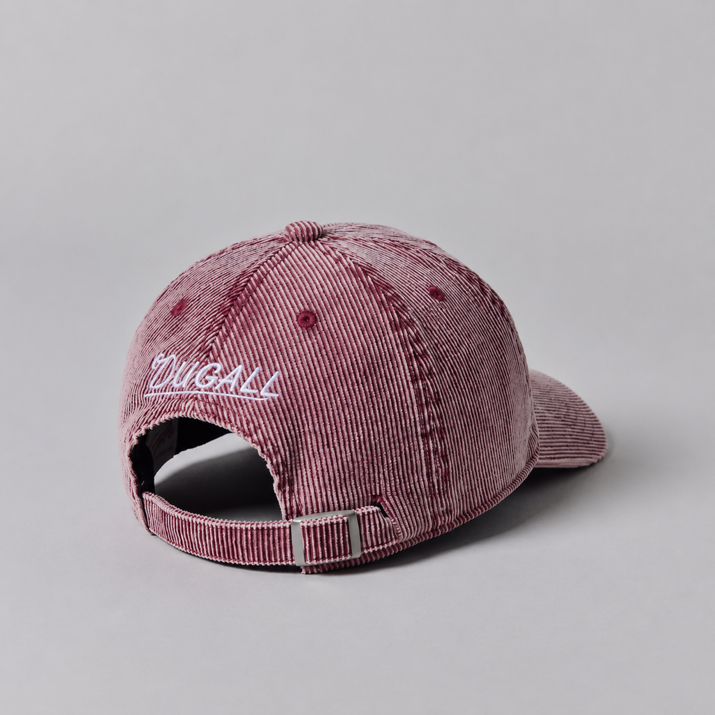 Back view of a custom washed pink corduroy baseball cap with adjustable metal buckle strap and embroidered back logo.