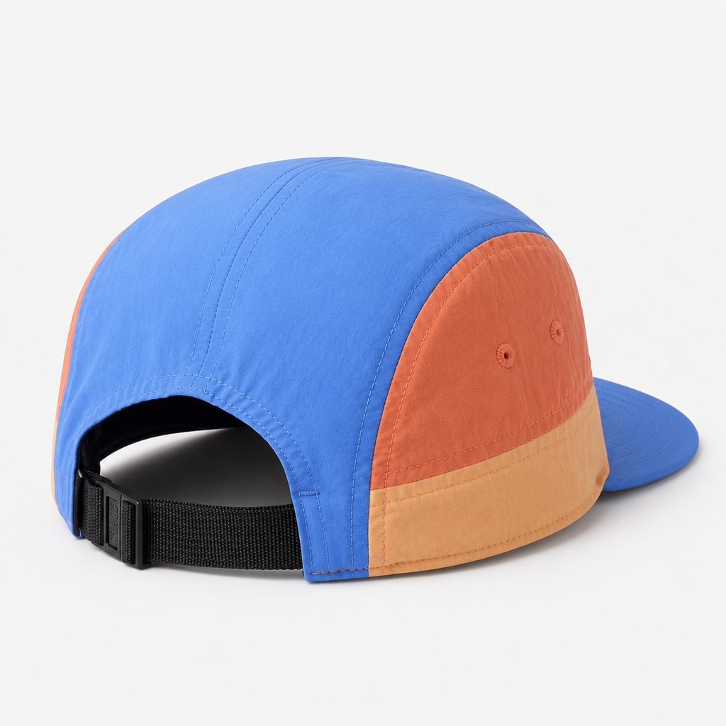 Back view of a color block nylon 5 panel cap with adjustable black webbing strap and orange side panels.