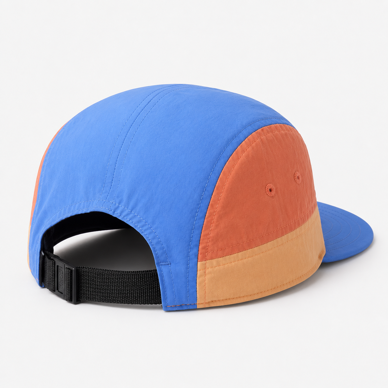 Back view of a color block nylon 5 panel cap with adjustable black webbing strap and orange side panels.