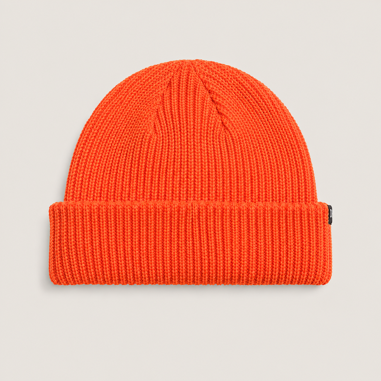 Back view of a bright orange short beanie in acrylic yarn with a clean minimalist design and cuffed silhouette