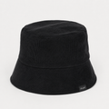 Back view of a black cotton bucket hat with corduroy-style ribbed fabric and side woven label