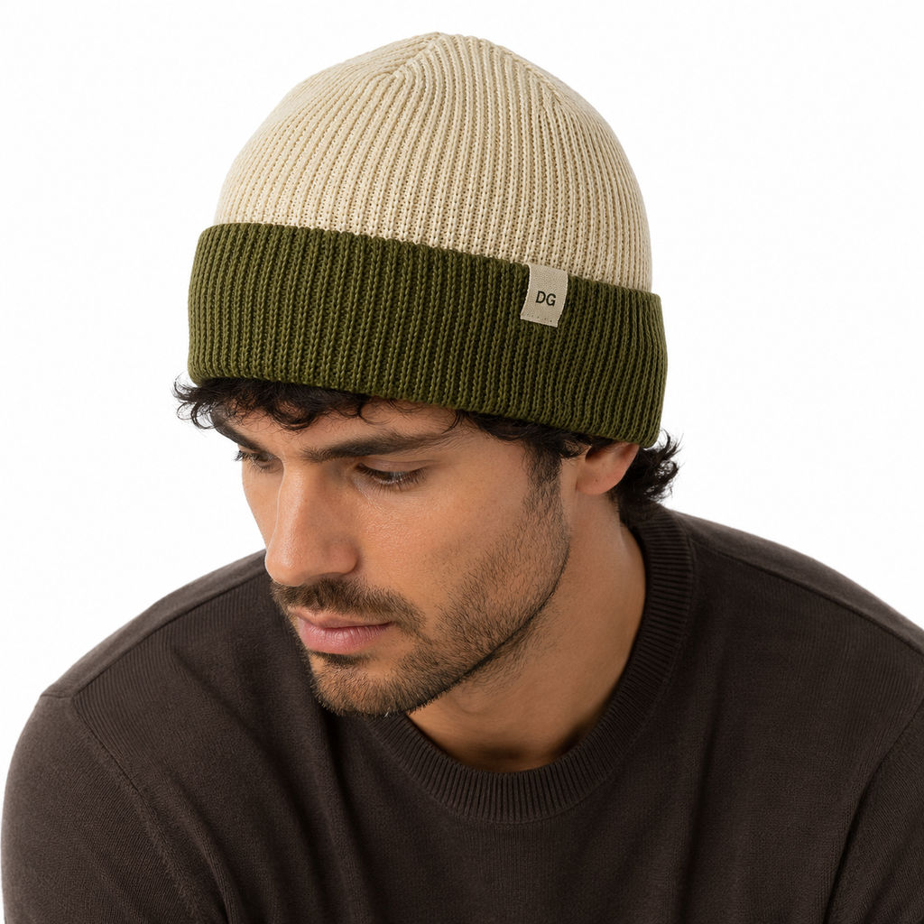 Male model portrait wearing a cream and olive cuffed short knit beanie with minimalist label accent