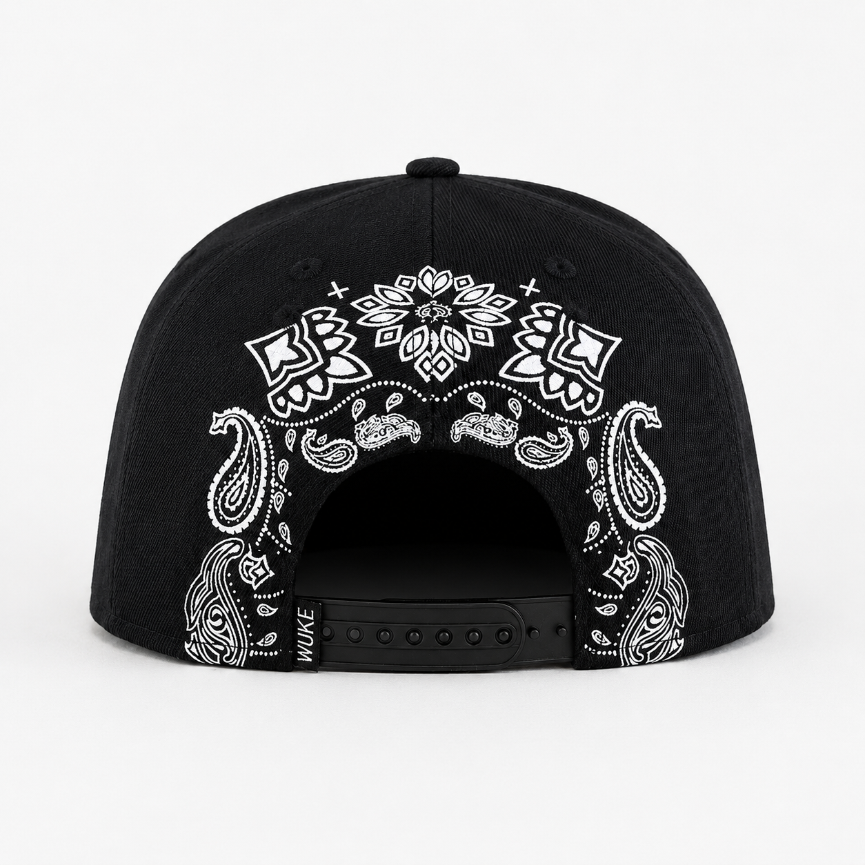 Back view of a black custom snapback hat with white bandana paisley pattern and adjustable snapback closure.