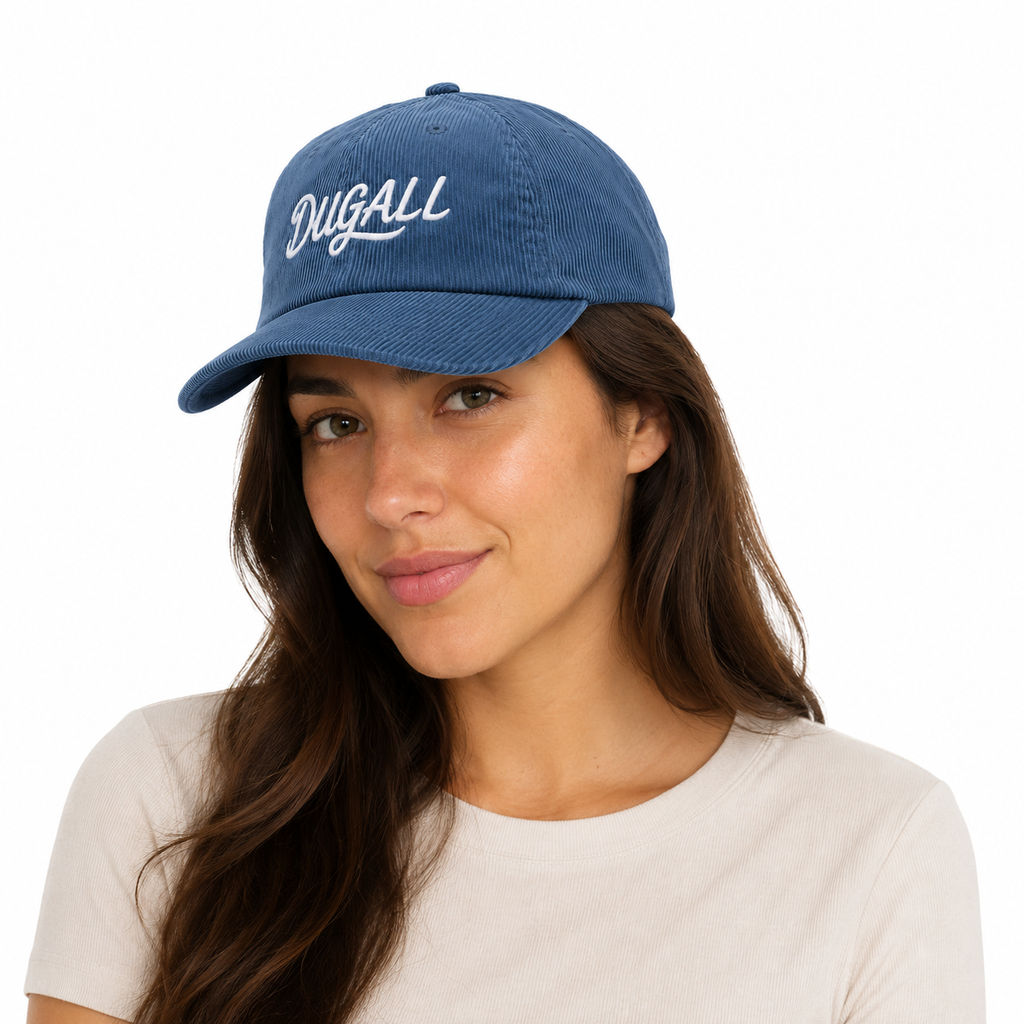 Woman wearing a blue custom corduroy dad hat with white embroidered DUGALL logo
