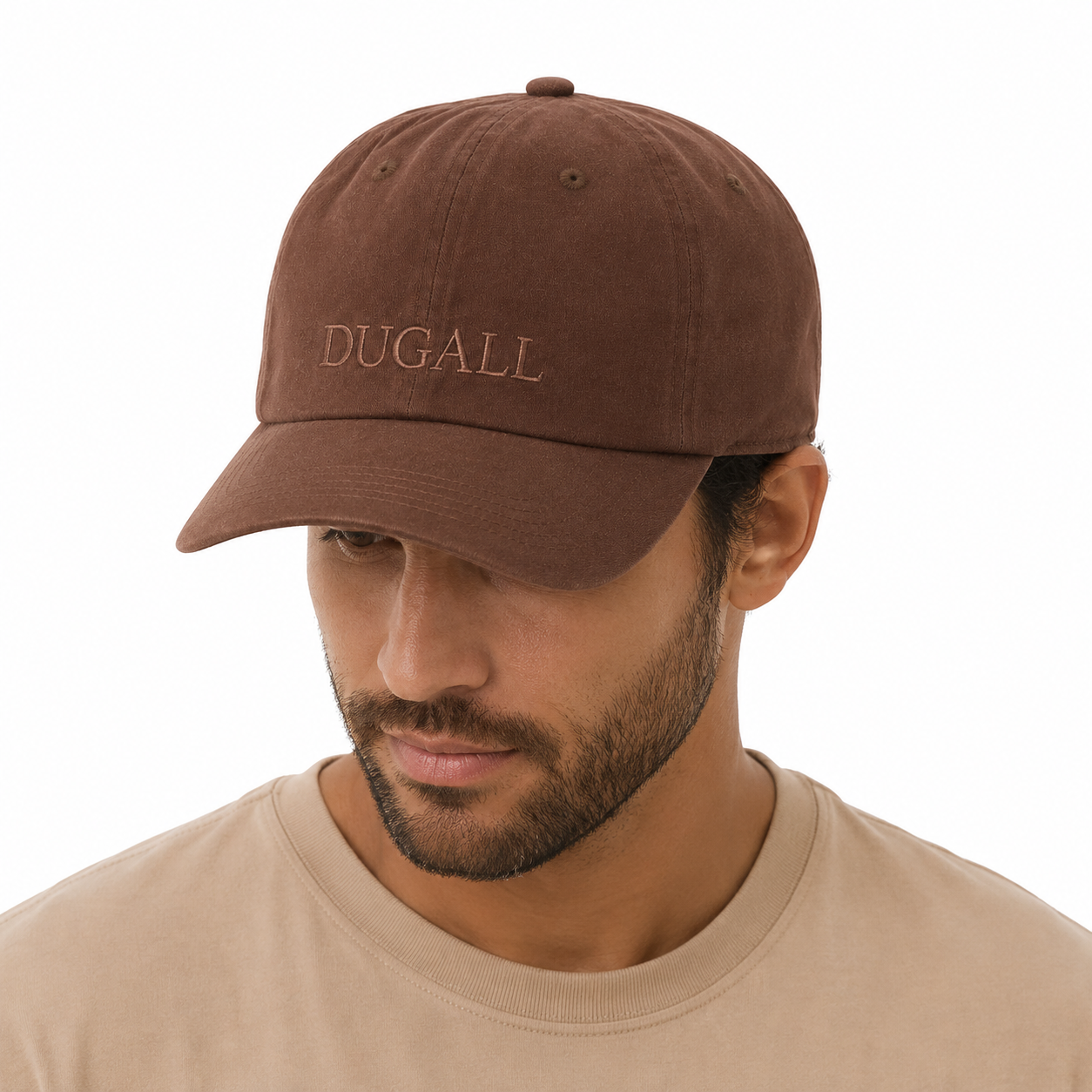 Male model wearing a brown custom snapback hat made from 100% cotton with subtle embroidered logo.