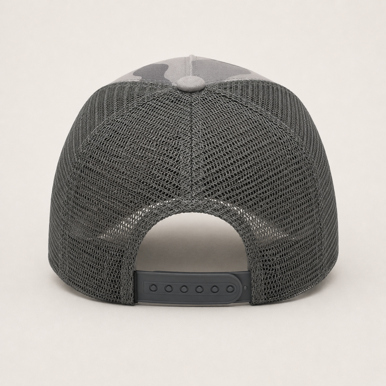 Back view of a custom camo trucker hat with breathable mesh panels and adjustable snapback closure.