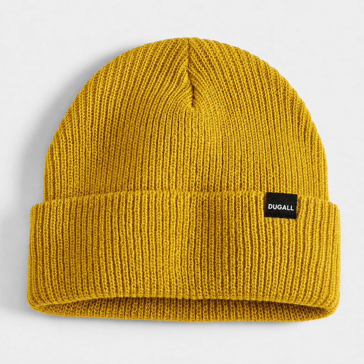 Mustard yellow acrylic ribbed beanie with folded cuff and custom woven label logo.