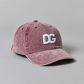 Front view of a custom pink corduroy snapback-style baseball cap with raised white 3D embroidered DG logo.