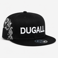 Black custom embroidered snapback hat with white front logo, flat brim, and bandana paisley side panel design.