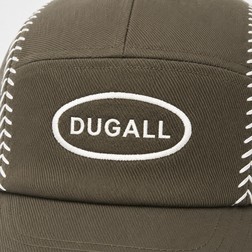 Close-up of custom embroidered DUGALL logo and white baseball stitch detail on olive cotton cap.