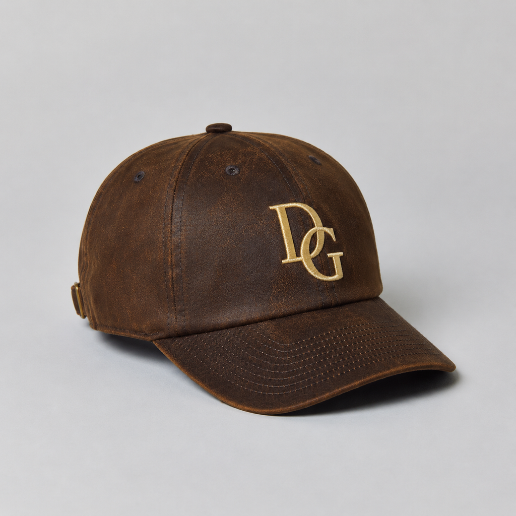 Brown PU leather dad hat with custom gold embroidery logo, curved brim, and vintage leather-look texture.