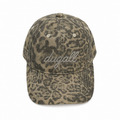Front view of a custom high quality washed cotton baseball cap with leopard print and rhinestone logo