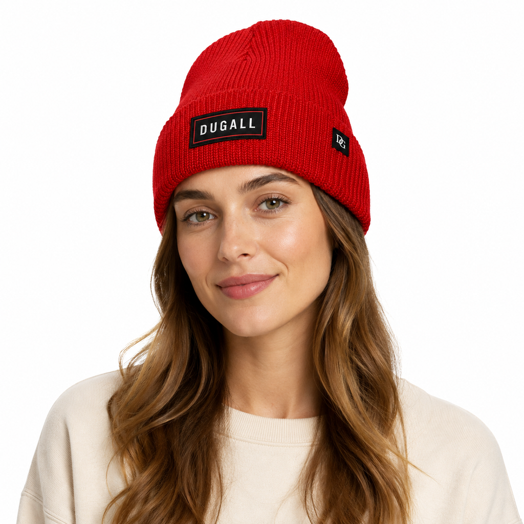 Female model wearing a red custom knit beanie with embroidered patch logo and side label branding.