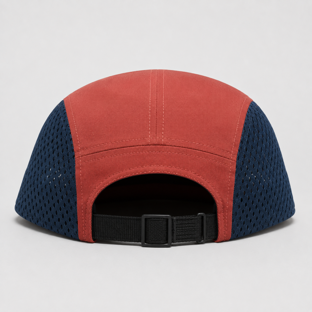 Back view of a custom mesh 5 panel cap with navy polyester mesh side panels and adjustable black webbing strap.