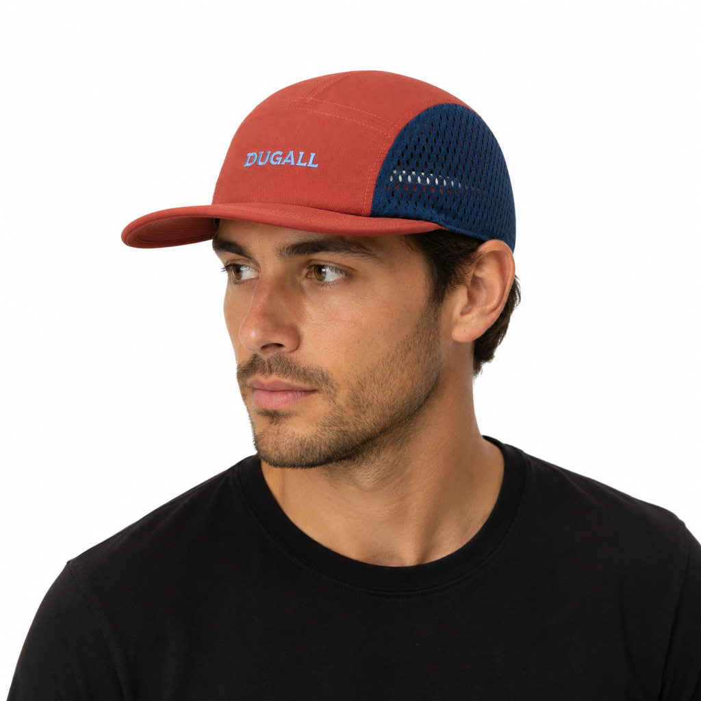 Male model wearing an orange and navy custom mesh 5 panel baseball cap with embroidered logo for outdoor sports and running.