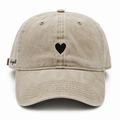 Front view of a custom high quality washed cotton vintage baseball cap with embroidered heart logo.