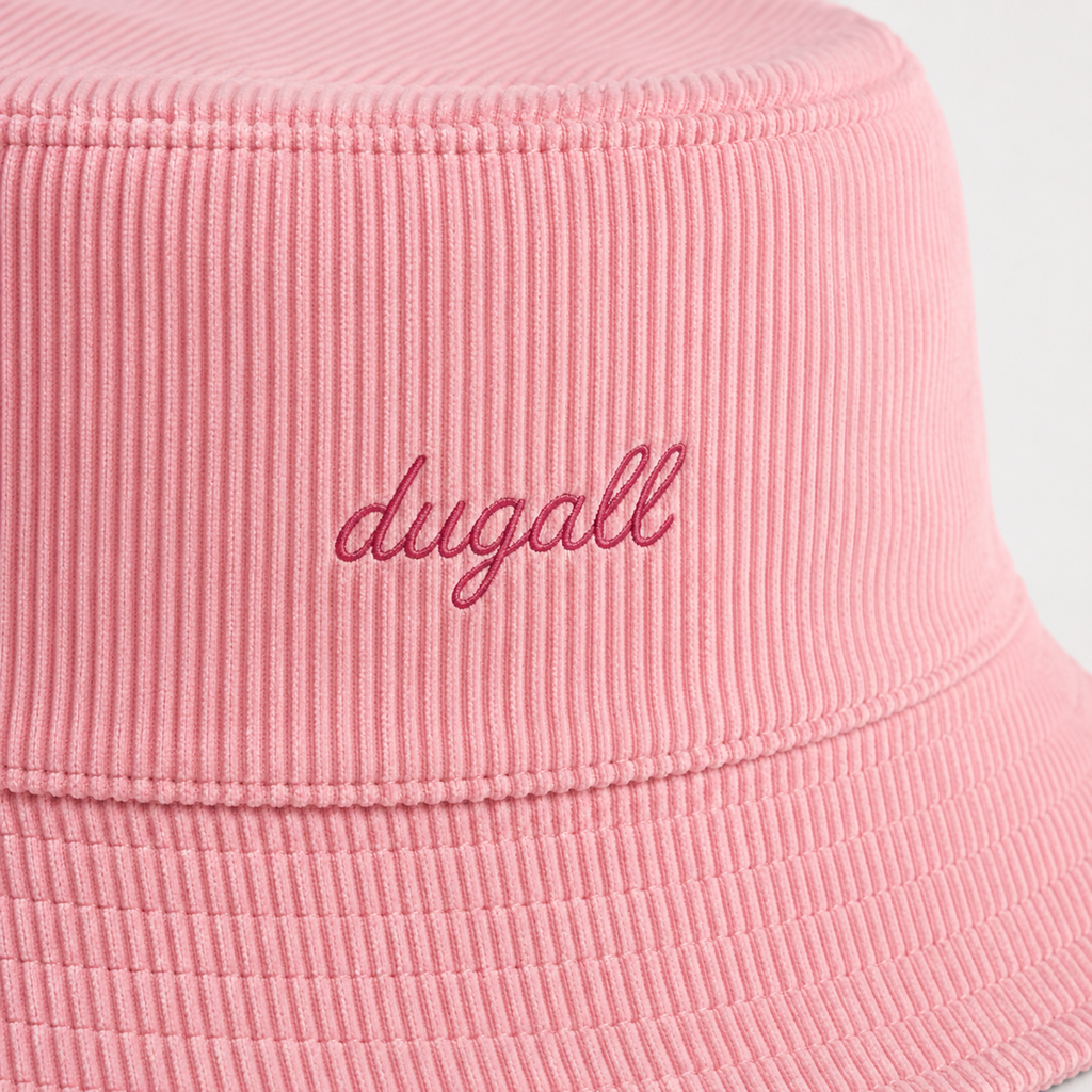 Close-up detail of embroidery logo on a pink cotton bucket hat with textured fabric.
