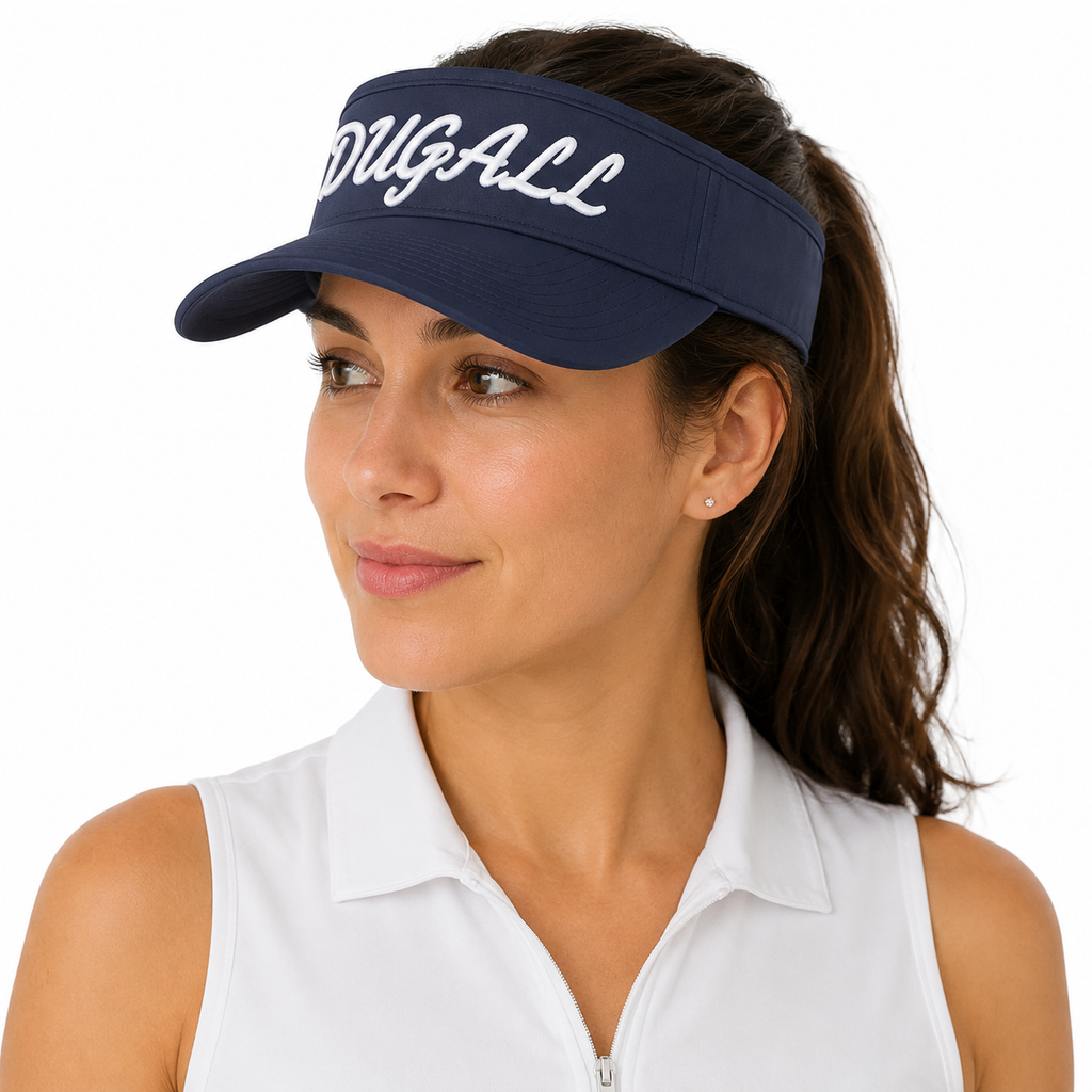 A woman wearing a navy blue visor with 'PGA All Pro' written in white script across the front, paired with a white sleeveless collared top, against a solid white background.