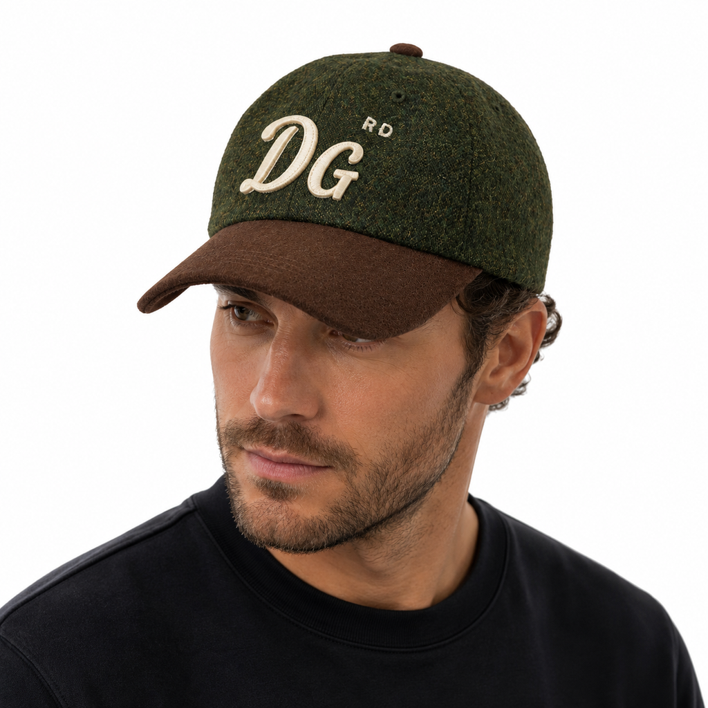 A man wearing a dark olive green and brown baseball cap with cream embroidered 'DG' and 'RD' lettering, shown in a close-up profile shot against a white background.