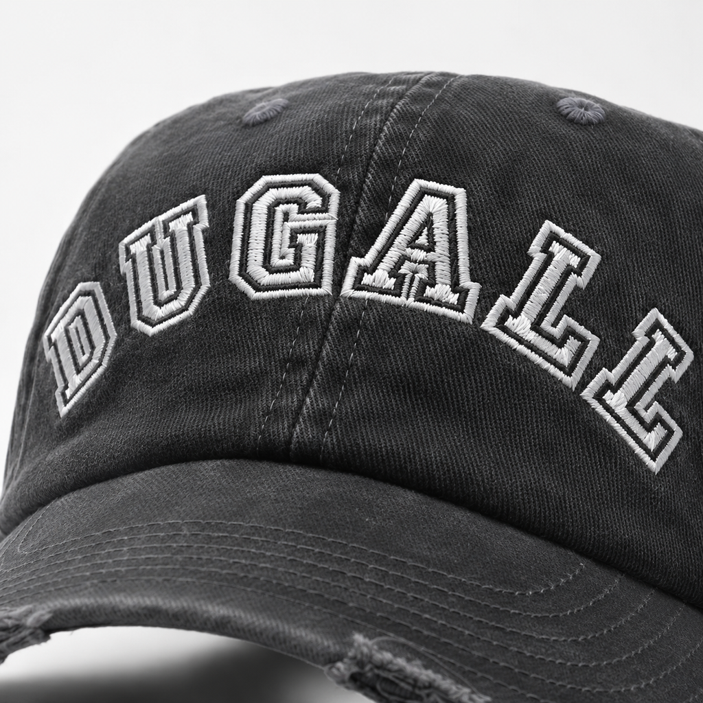 Close up of white embroidered DUGALL logo on a black washed 100% cotton dad hat.
