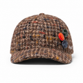 Front view of a high quality custom 100% wool baseball cap with decorative buttons, curved brim and side embroidered logo.