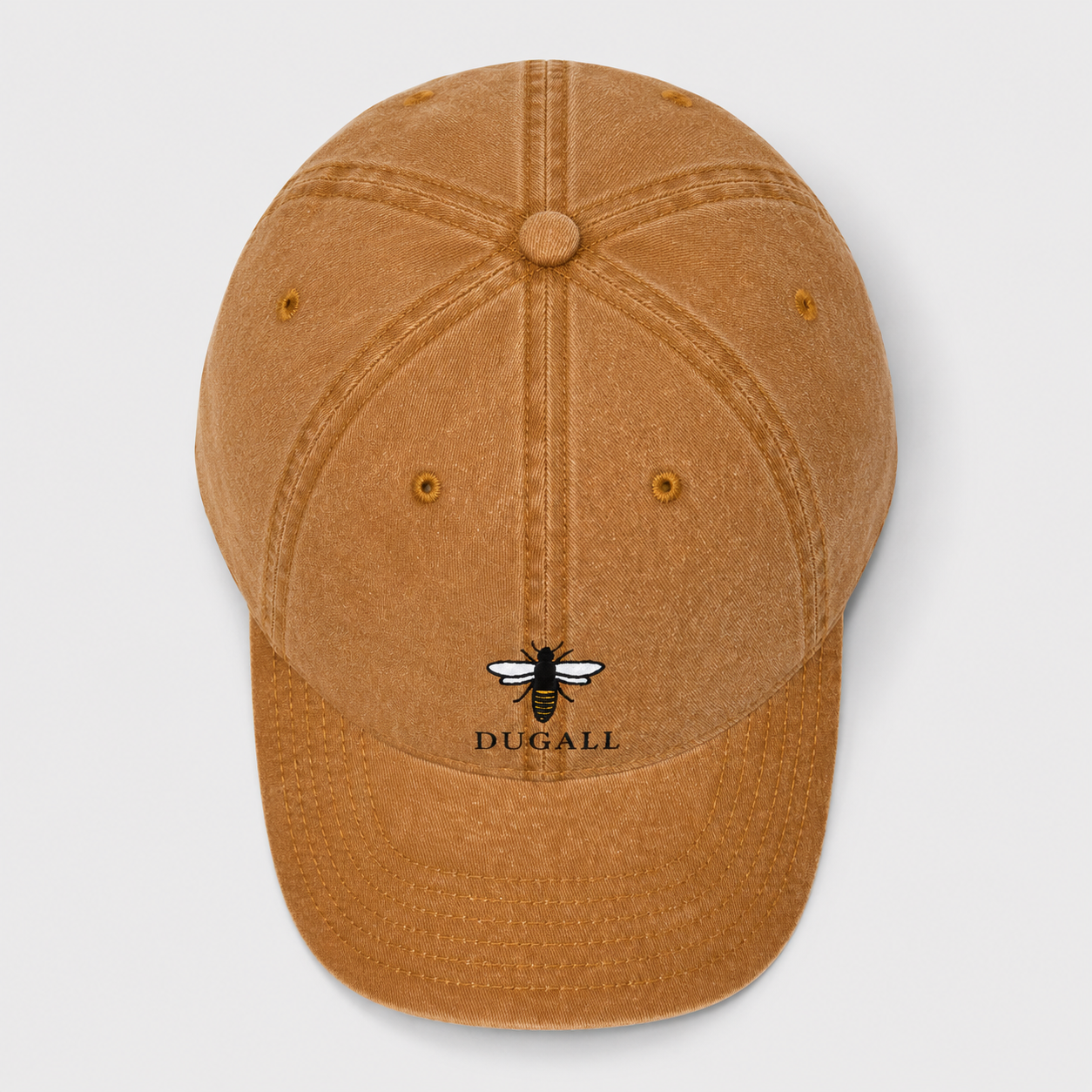Top view of a honey brown washed cotton dad hat showing six panel construction and bee logo placement.