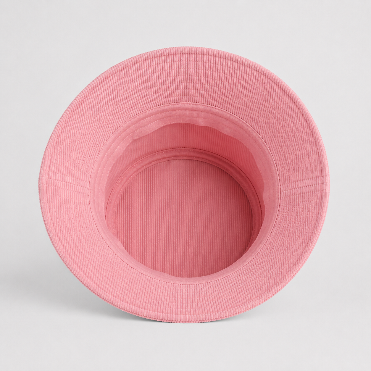Top interior view of a pink 100% cotton bucket hat showing the inner construction.