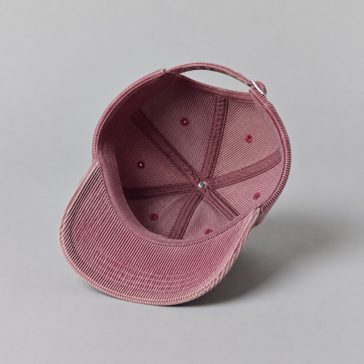 Interior view of a custom 6 panel corduroy baseball cap showing clean construction, curved brim, and adjustable strap.
