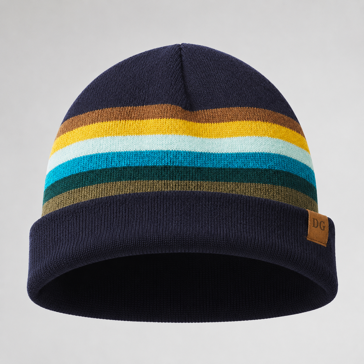 Bottom view of a retro striped acrylic ski beanie showing folded cuff, knit structure, and custom patch placement.