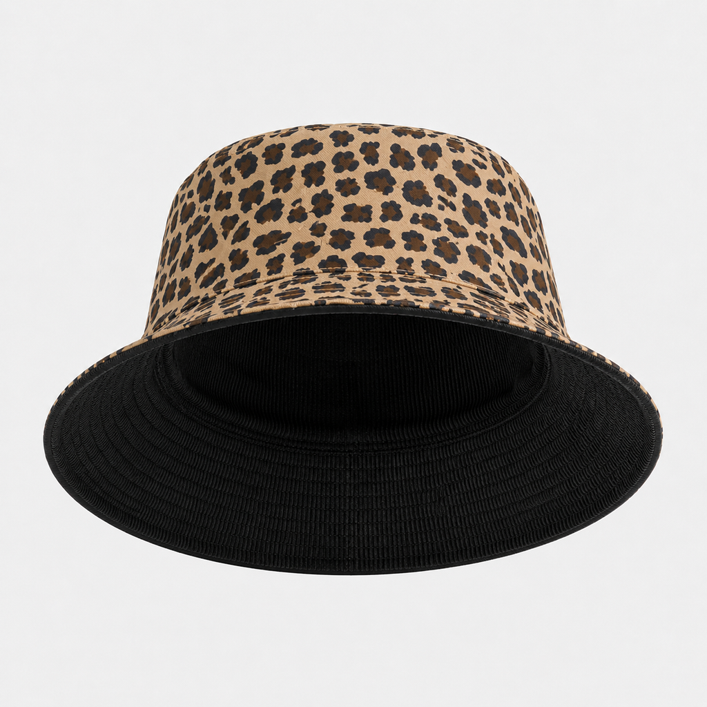A bucket hat featuring a beige and brown leopard print crown with a solid black brim, shown against a light gray background.