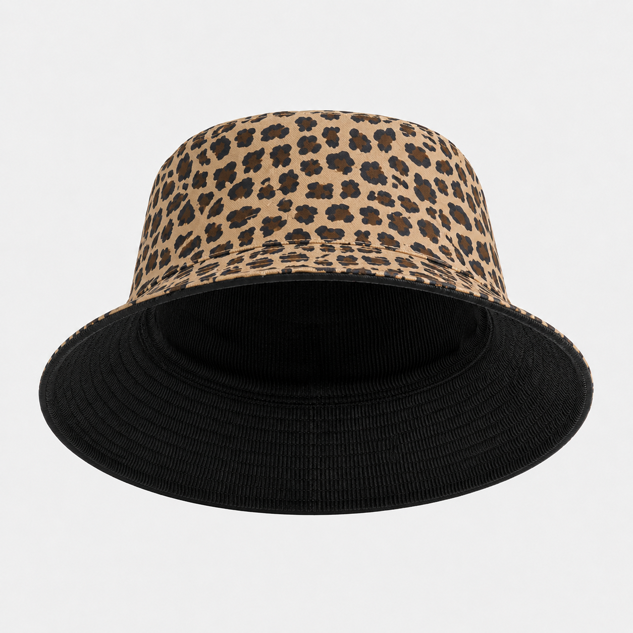 A bucket hat featuring a beige and brown leopard print crown with a solid black brim, shown against a light gray background.