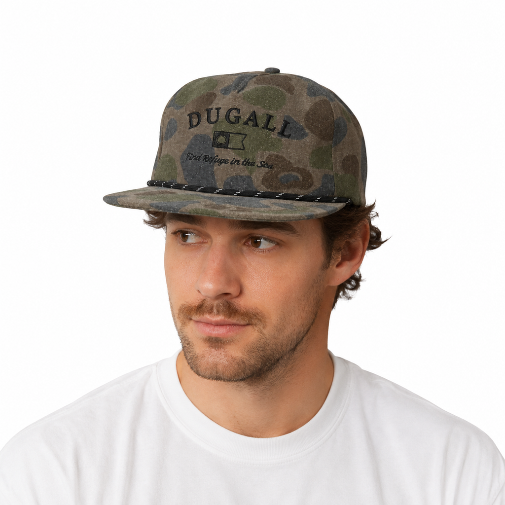 Male model wearing a custom camo snapback hat with embroidered logo and rope detail for outdoor camping and fishing style.
