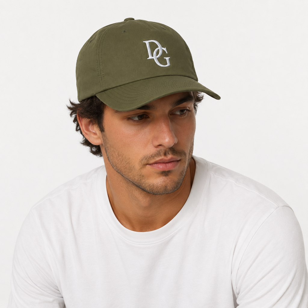 Male model wearing a custom olive green cotton twill baseball cap with embroidered DG logo and adjustable fit.