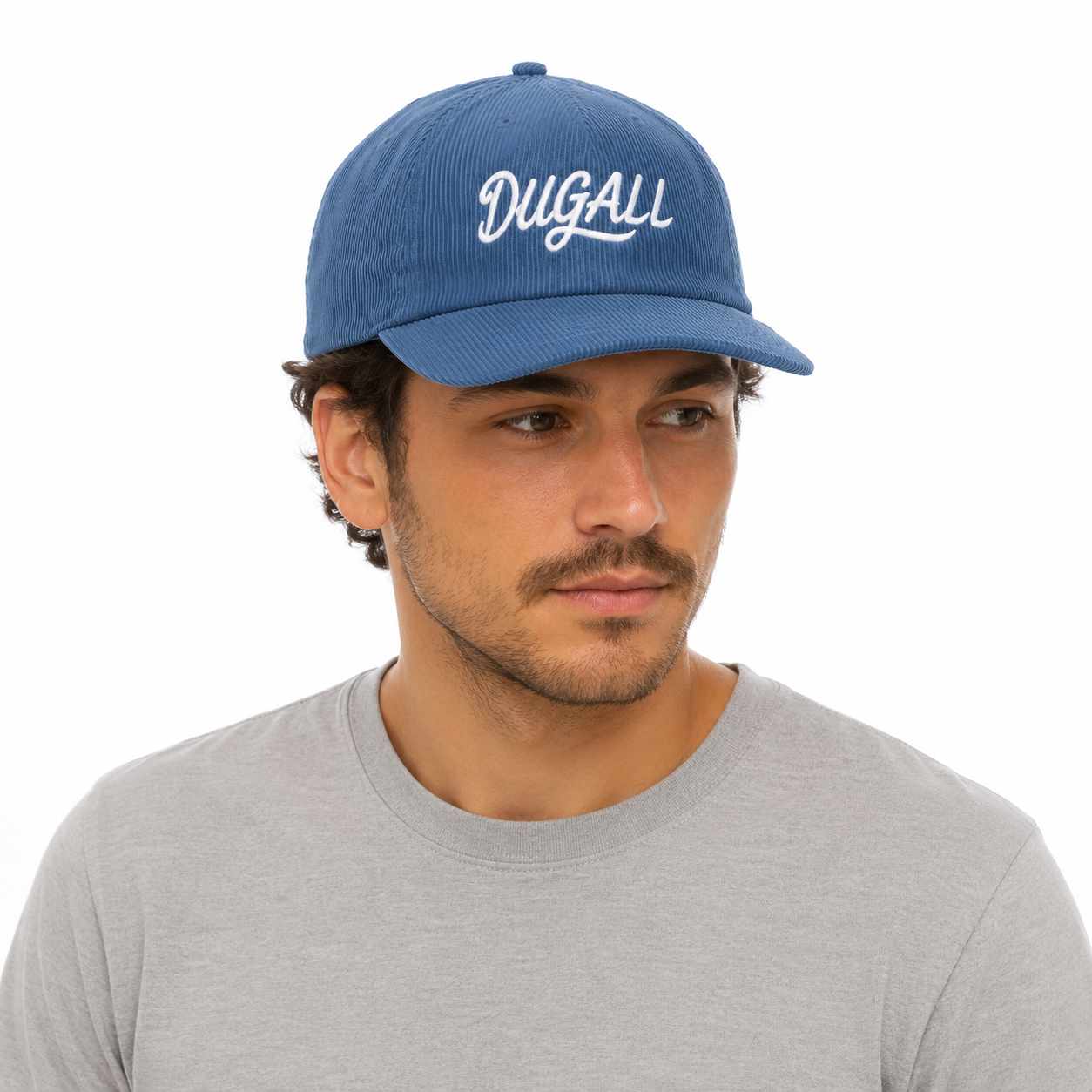 Man wearing a blue custom corduroy dad hat with white embroidered logo