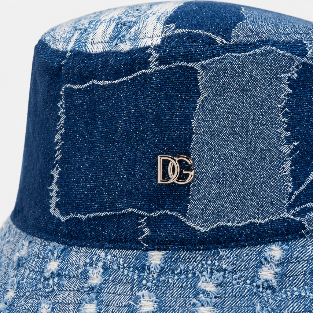 Close-up of a custom denim bucket hat with patchwork fabric and metal DG logo detail